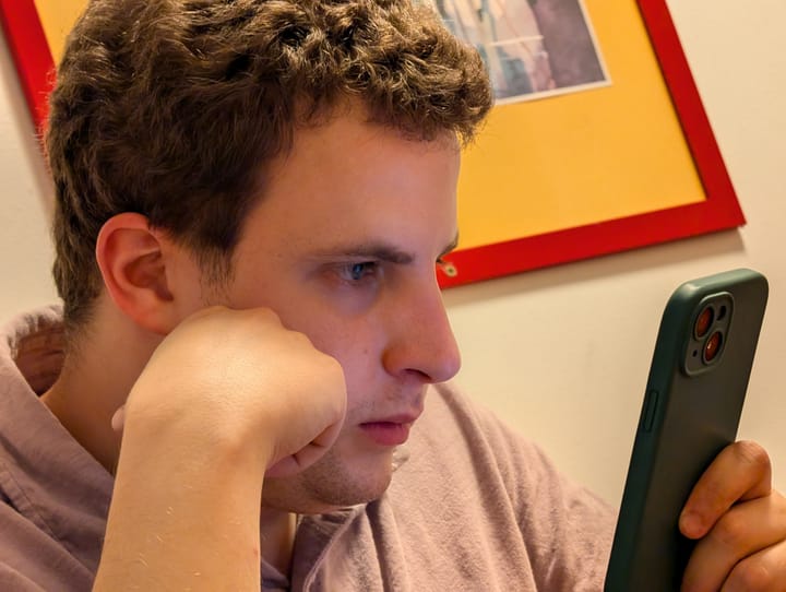 Cory looking at an iPhone while travelling